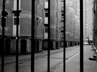 Prison Marolles This photo does not show a real prison, it is a shot taken in the Marolles, a well-known district in Brussels, which unfortunately has not such a good reputation for some time. Years ago when this photo was taken (somewhere in 2015) you could still walk around with a camera over there, Today you would probably have be robbed very quickly, because the streets are now full of youth rascals, gangs and drug users.