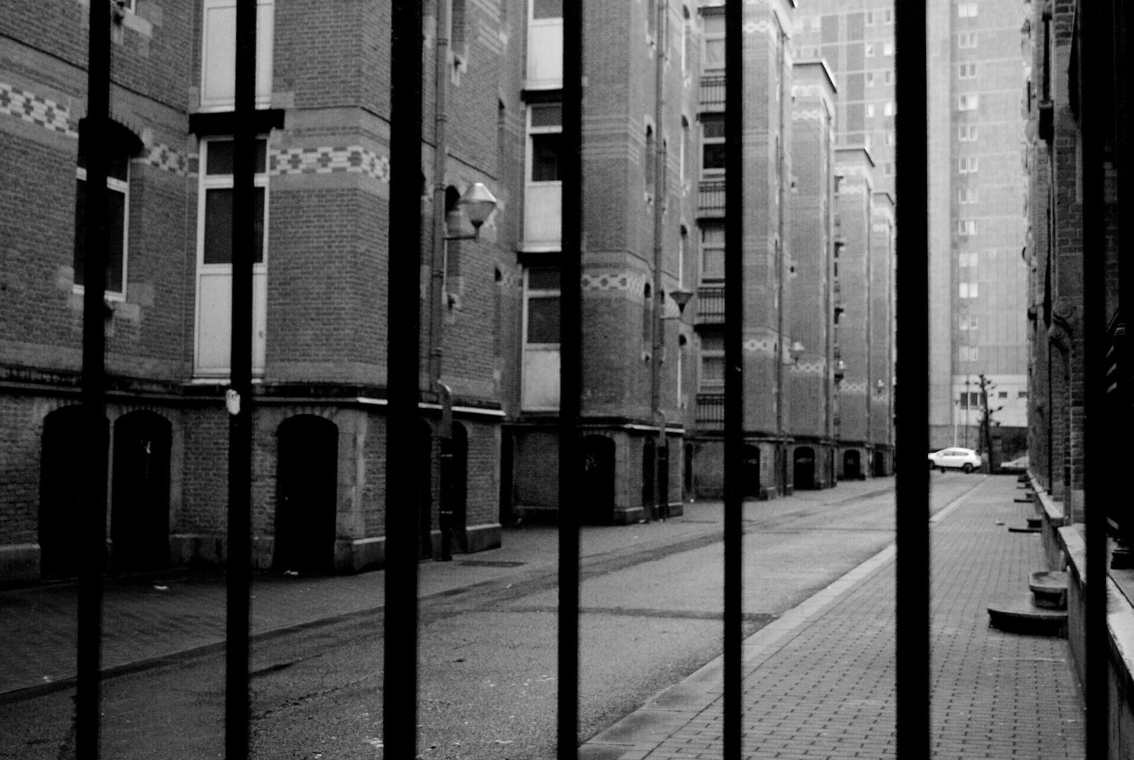 This photo does not show a real prison, it is a shot taken in the Marolles, a well-known district in Brussels, which unfortunately has not such a good reputation for some time. Years ago when this photo was taken (somewhere in 2015) you could still walk around with a camera over there, Today you would probably have be robbed very quickly, because the streets are now full of youth rascals, gangs and drug users.