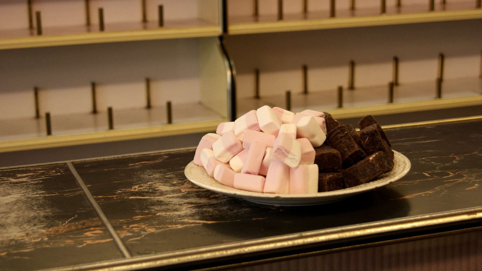 A plate with marshmallows photographed in an old grocery store that was about to close for good in 2010. Photo made with the old Sony A330 DSLR.
